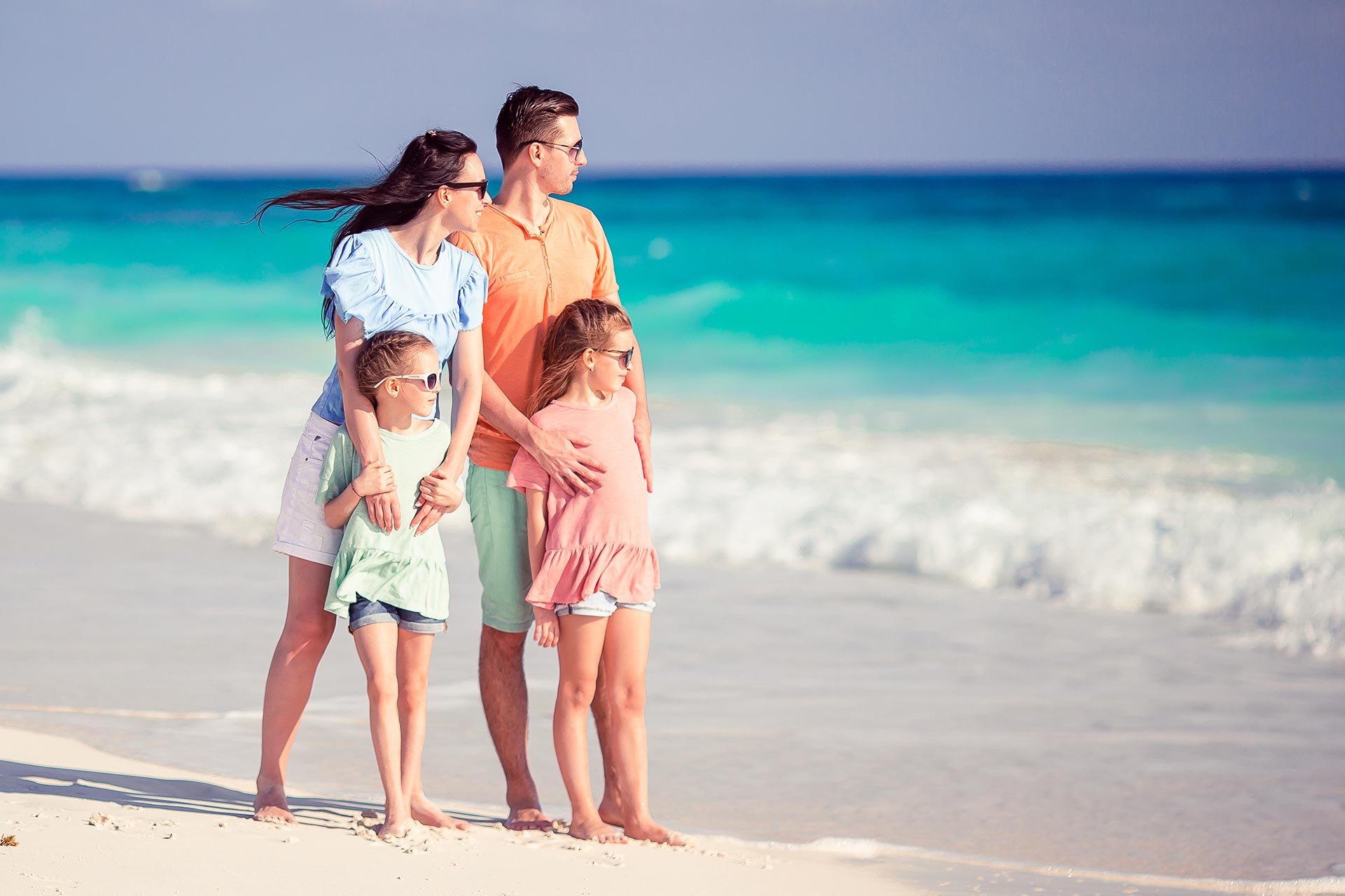 happy-family-with-kids-on-the-beach-together-48TSWKF